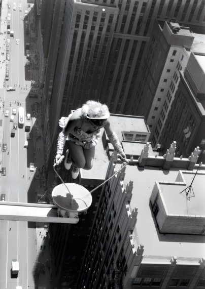 Photo of a young woman skipping rope on a tiny platform outside a skyscraper high above the streets of Chicago.