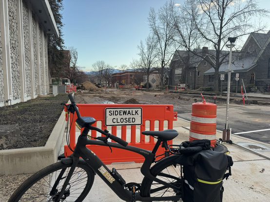 My bike in front of the “sidewalk closed” sign at 8th & State. 8th St is mud after yesterday’s water main break.