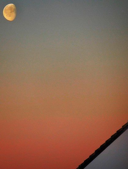 Foto shows Moon at dawn, top left, plus roof, down right.