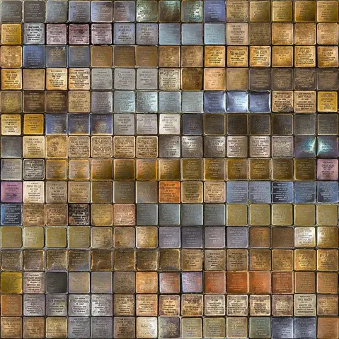 The image appears to show a large arrangement of small metal plaques. Each plaque likely contains engraved text. These kinds of plaques are often used to commemorate individuals, typically those who were victims of historical events, and can be found in public spaces to honor their memory. If you have specific questions about the image or its context, feel free to ask!

Image Credits: Wikimedia / BVBMario / CC BY-SA 4.0