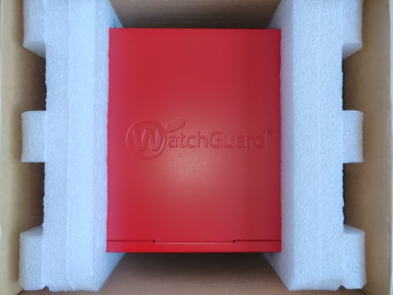 Open package with a red appliance inside.