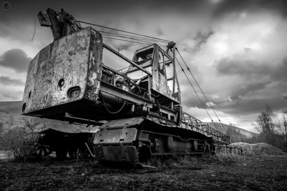 Monochrome shot of old wrecked mining crane