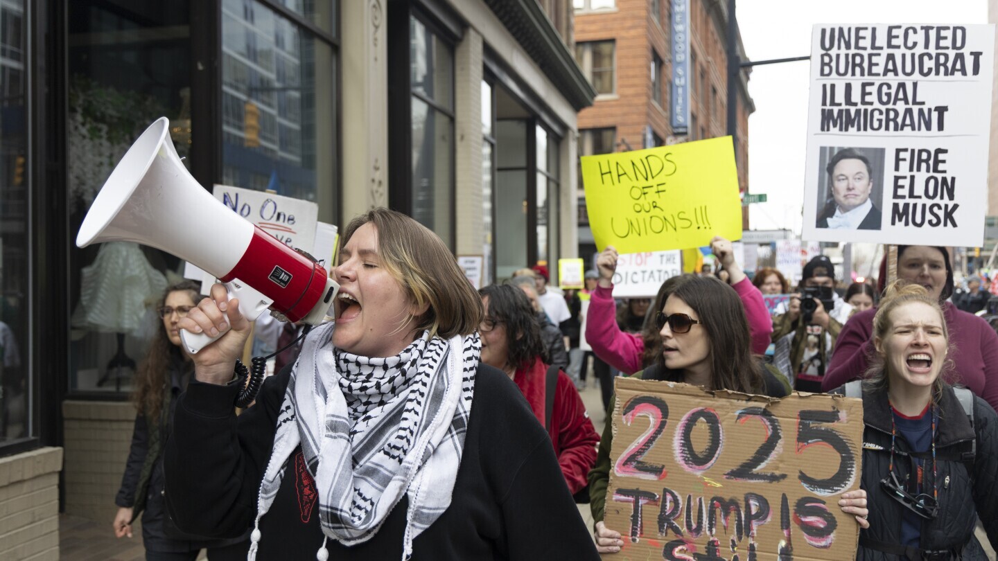 Community organizer Emerson Wolfe leads a march hosted by Indivisible Greater Grand Rapids down Ottawa Avenue during a Hands Off! rally, April 5, 2025, in Grand Rapids, Mich. (Arthur H. Trickett-Wile/The Grand Rapids Press via AP)
