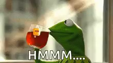 kermit the frog is drinking a cup of tea from a cup .