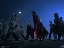 a man in red pants is dancing in front of a crowd of people