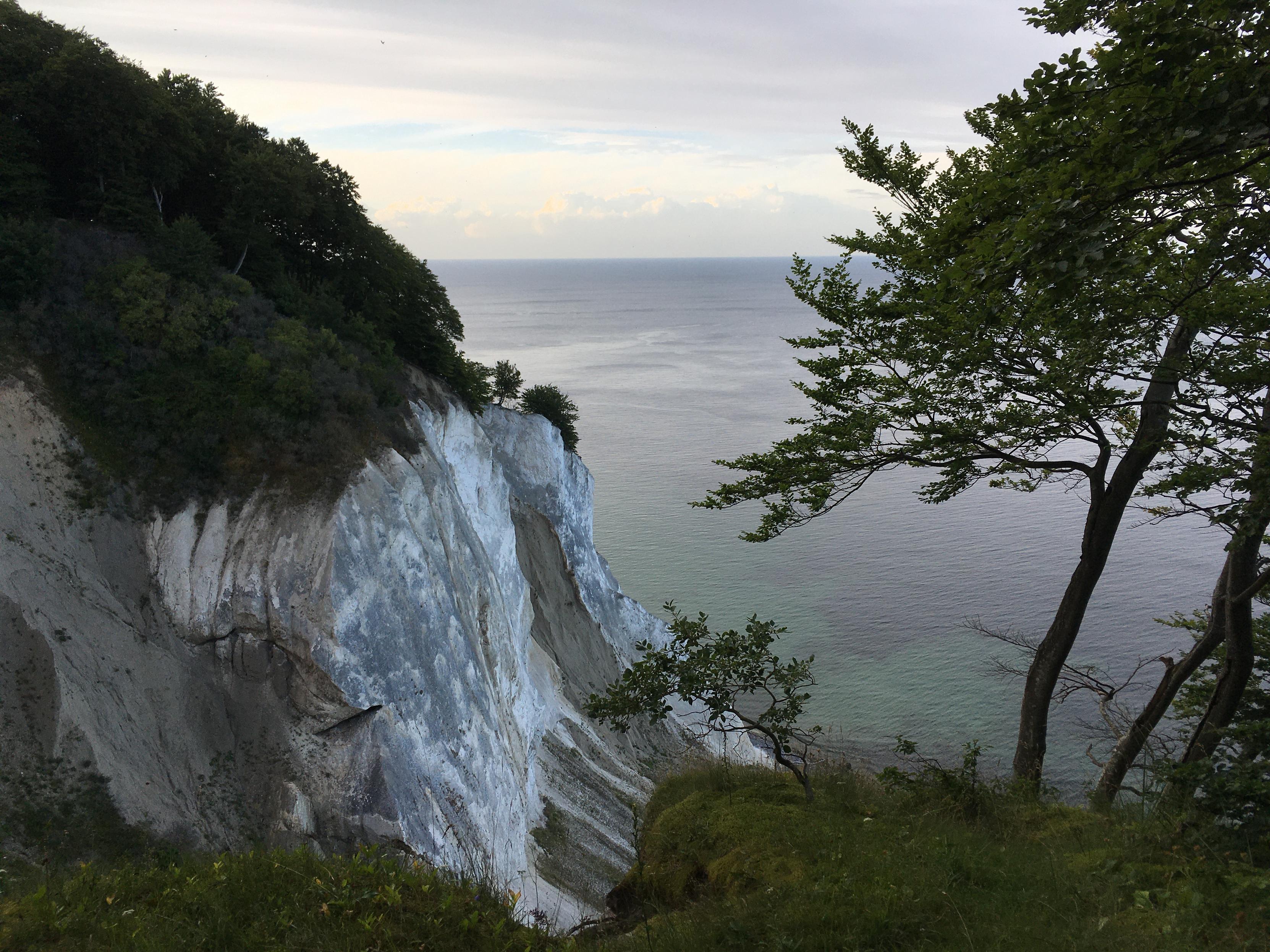 Standing on top of the Chalk cliffs of Møn (Denmark) and looking north-east towards the baltic sea. Trees are hugging the cliffs.
That evening I experienced a funny light and I tried to capture this by overworking the photo at the PC - usually I don’t do that.